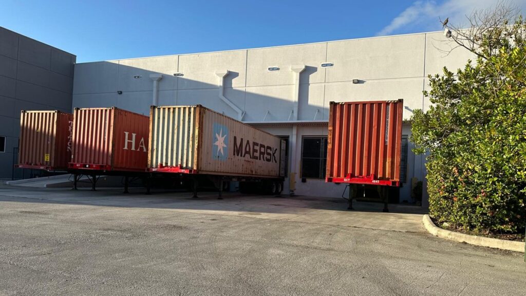 Shipping containers at the Priority Fulfillment loading docks in Medley, FL